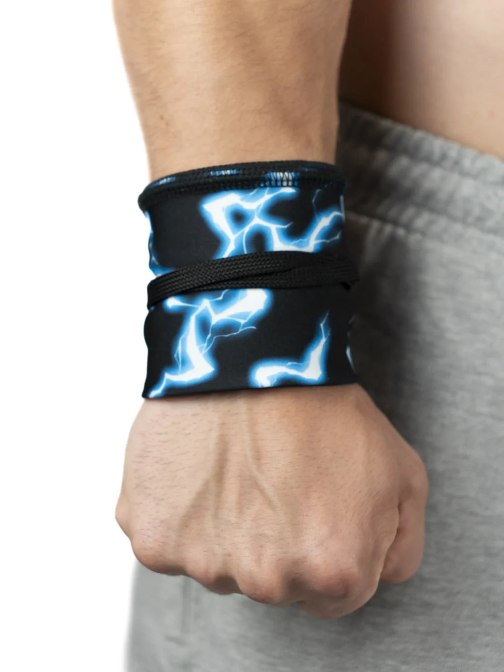 An athlete's wrist securely wrapped with the RHSM Godmode Wrist Wraps V2, providing support for lifting.