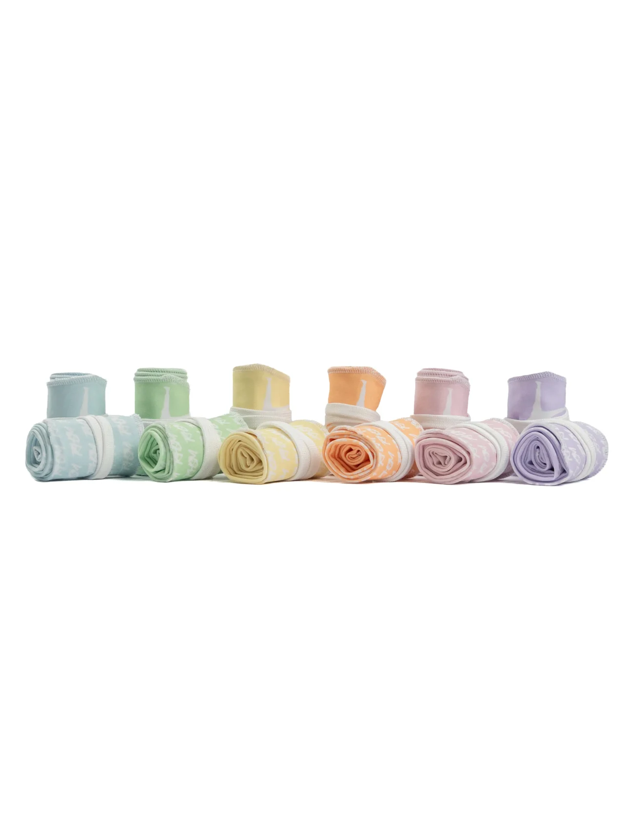The complete RHSM V2 Pastel Collection rolled up, showcasing all six colorways including lilac, pastel blue, pastel green, pastel pink, pastel yellow, and peach.