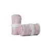 A pair of the pastel pink RHSM Calisthenics Wrist Wraps V2 rolled up and ready for training.