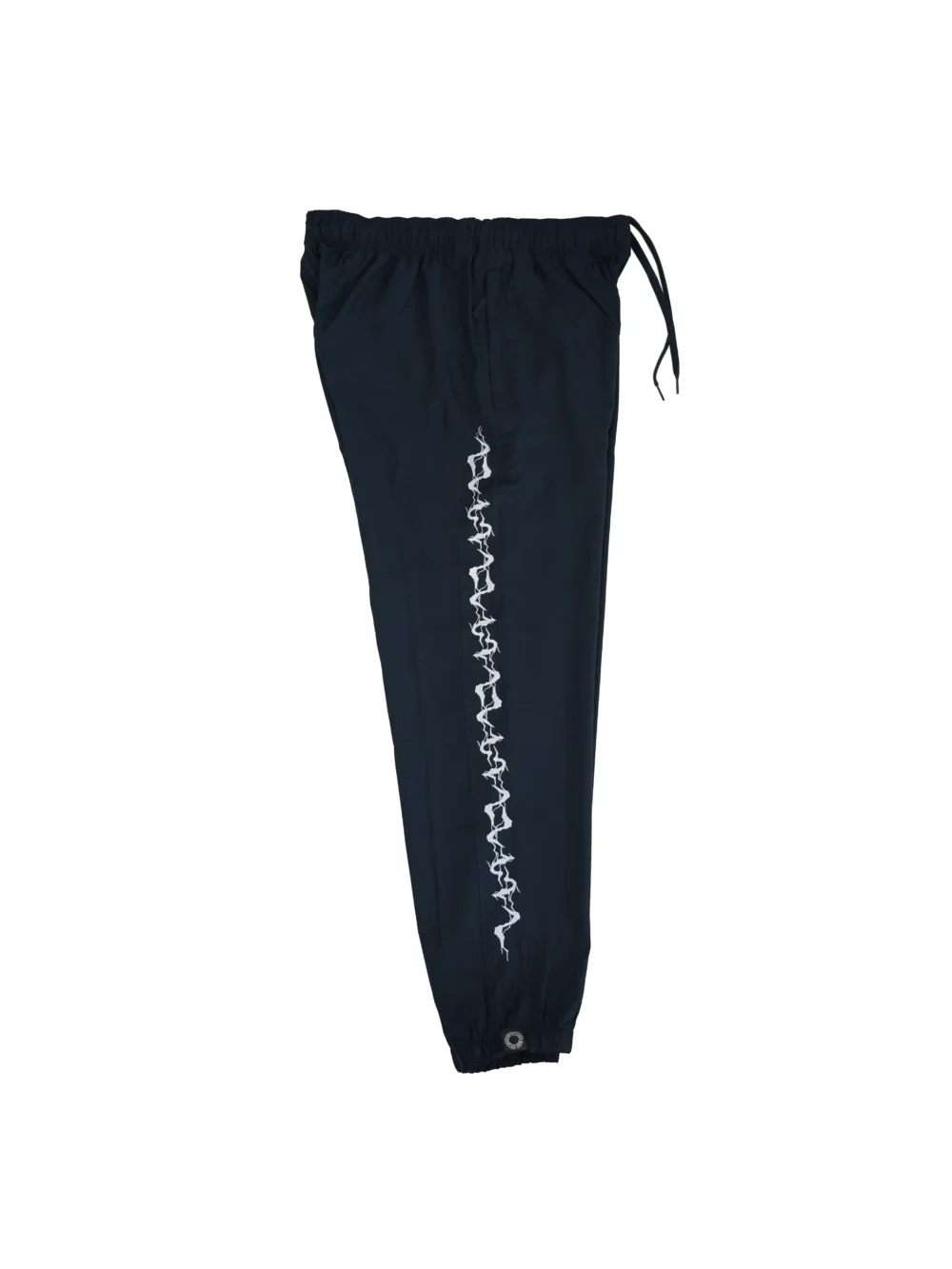 The navy GODMODE trackpants laid flat (side view), providing a full view of the bold lightning graphic design down the leg.