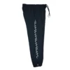 The navy GODMODE trackpants laid flat (side view), providing a full view of the bold lightning graphic design down the leg.