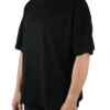 A female model wearing the black oversized boxy tee from the front, demonstrating its modern boxy silhouette and dropped shoulder fit.