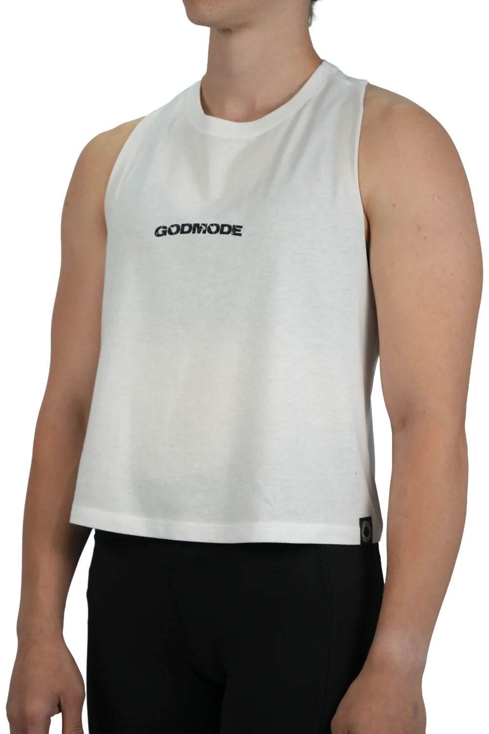 Model wearing the white "GODMODE" cropped tank (front view), showing the modern cropped fit of this essential women's workout gear.
