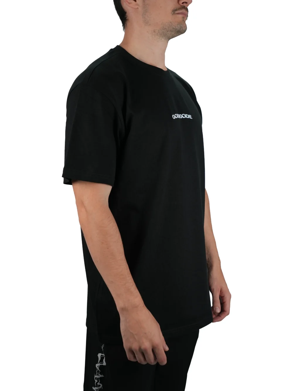 Model wearing the black oversized "GODMODE" tee (front view), demonstrating the loose fit and dropped shoulders of this workout gear.