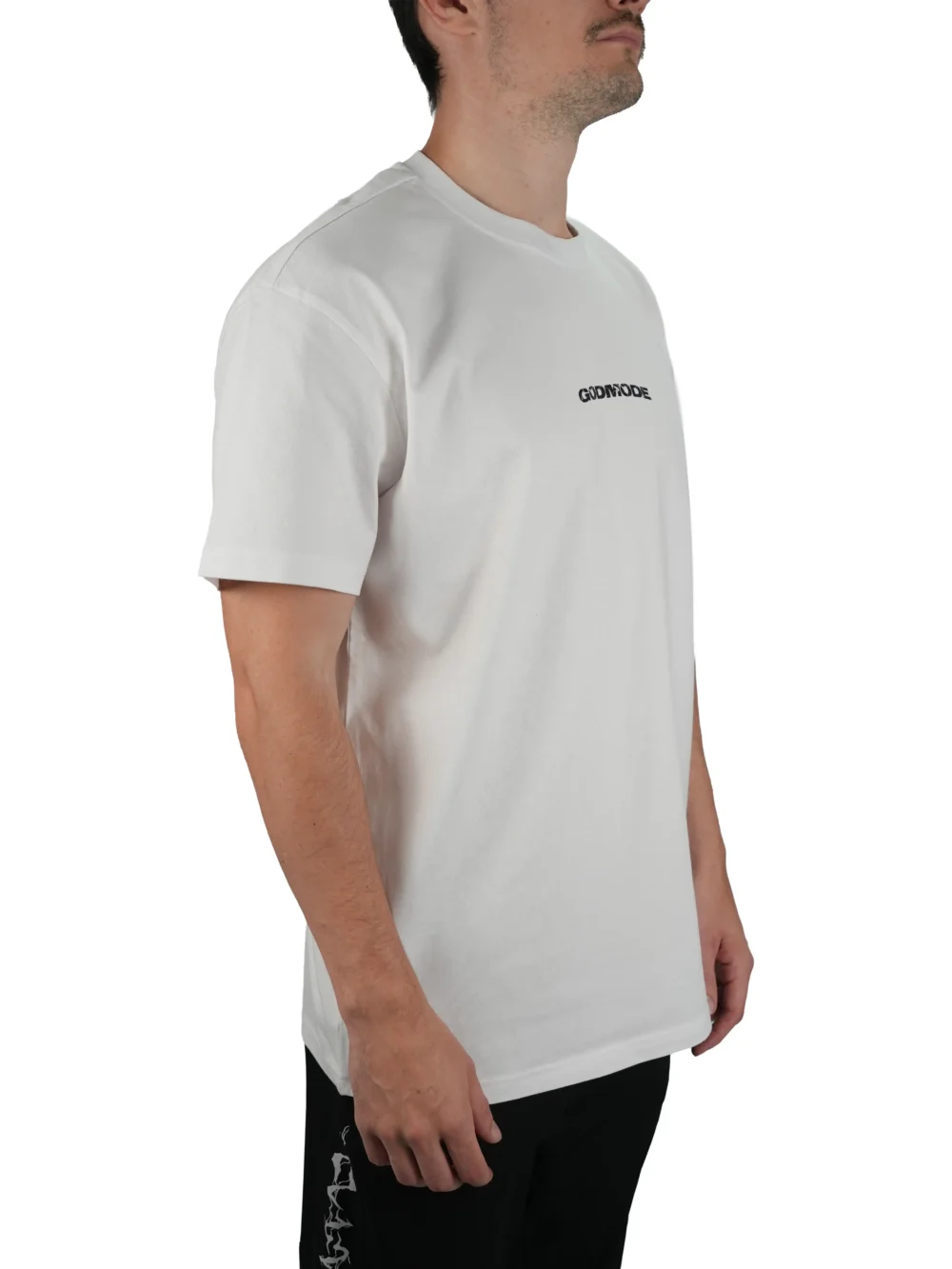 Model wearing the white oversized "GODMODE" tee (front view), showing the modern oversized fit of this essential workout gear.