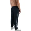Model wearing the navy "GODMODE" trackpants (back view), showcasing the performance silhouette from the calisthenics clothing brand RHSM.