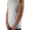Model wearing the white oversized tank (front view), showing the modern loose fit of this premium workout gear.