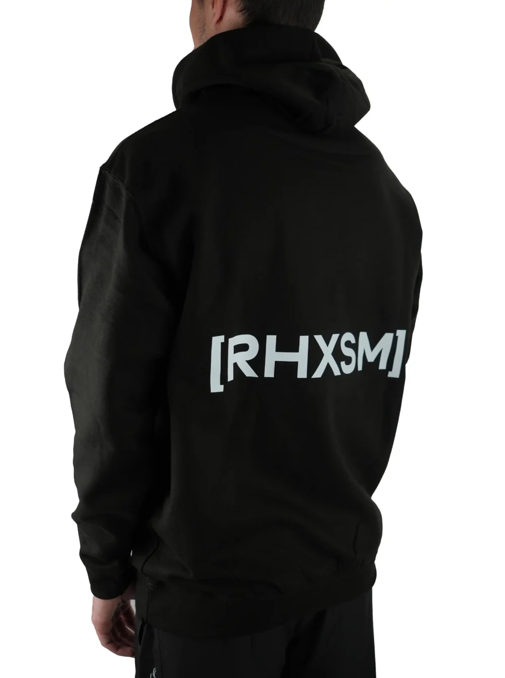 Model wearing the black "[RHXSM]" hoodie (back view), representing the mindset of resilience with the powerful statement back graphic from the calisthenics clothing brand RHSM.
