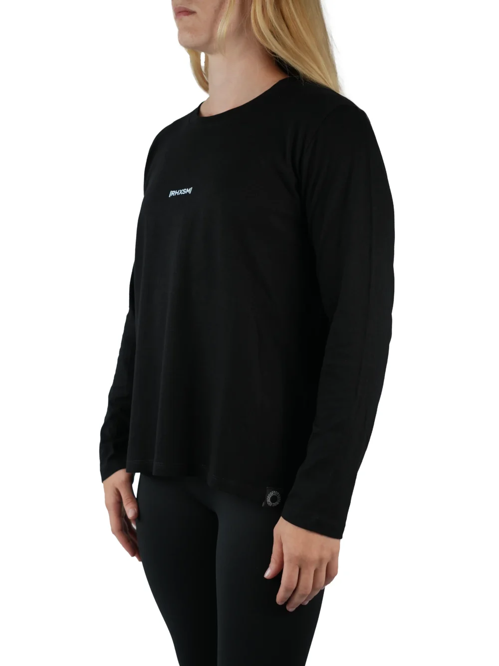 Model wearing the black "[RHXSM]" long sleeve tee (front view), demonstrating the comfortable fit of this women's workout gear.