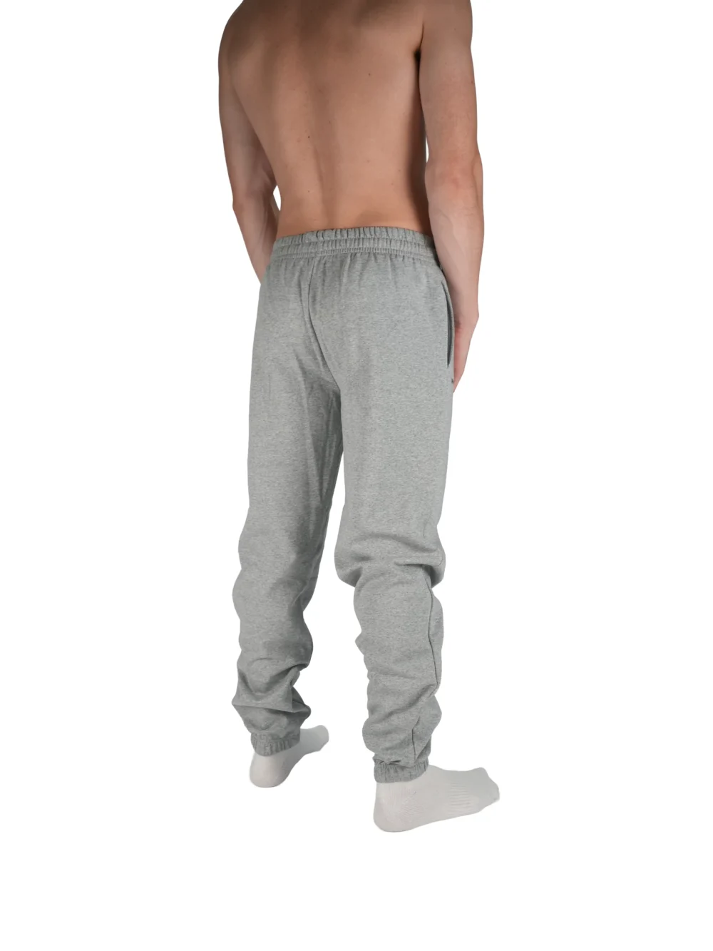Model wearing the grey "[RHXSM]" sweatpants, demonstrating the comfortable, relaxed fit of this versatile workout gear.