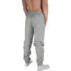 Model wearing the grey "[RHXSM]" sweatpants, demonstrating the comfortable, relaxed fit of this versatile workout gear.