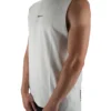 Model wearing the white oversized "[RHXSM]" tank (front view), showing the modern oversized fit of this essential workout gear.