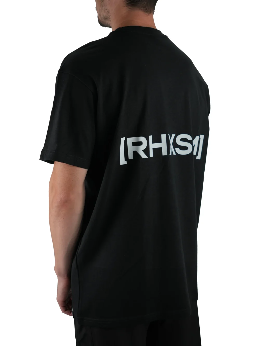Model wearing the black "[RHXSM]" tee (back view), representing resilience with the powerful back graphic from the calisthenics clothing brand RHSM.