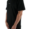 Model wearing the black oversized "[RHXSM]" tee (front view), demonstrating the loose fit and dropped shoulders of this workout gear.