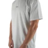 Model wearing the white oversized "[RHXSM]" tee (front view), showing the modern oversized fit of this essential workout gear.