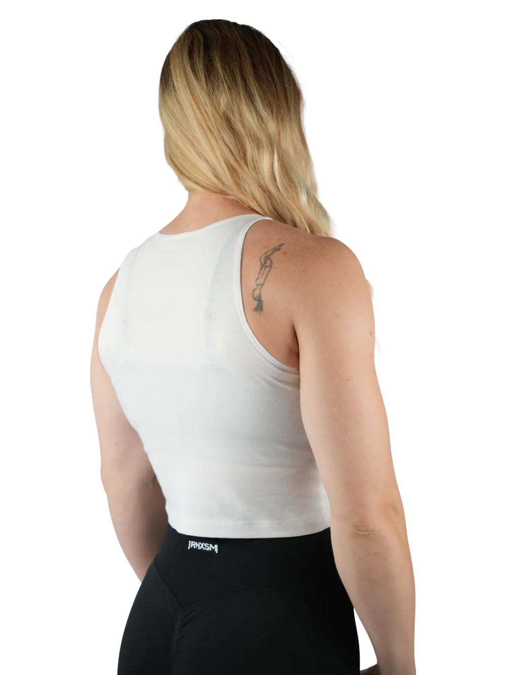 Model wearing the white "[RHXSM]" crop top (back view), demonstrating the freedom of movement provided by the racerback design.