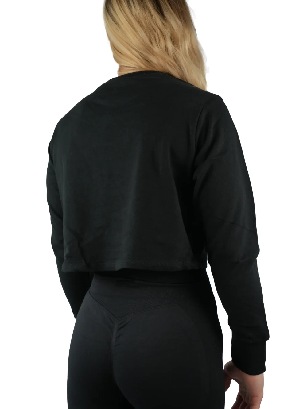 Model wearing the black "[RHXSM]" cropped crew (back view), showcasing the relaxed silhouette from the calisthenics clothing brand RHSM.