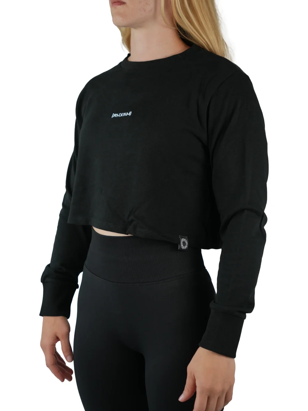 Model wearing the black "[RHXSM]" terry cropped crew (front view), demonstrating the oversized, belly-free fit of this women's workout gear.
