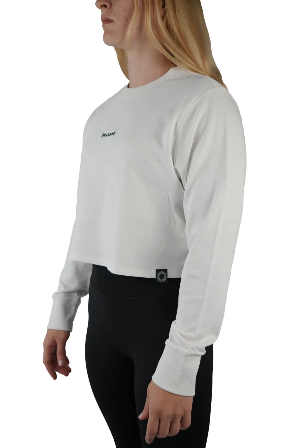 Model wearing the white "[RHXSM]" terry cropped crew (front view), highlighting the soft 100% cotton terry of this essential women's workout gear.