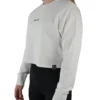 Model wearing the white "[RHXSM]" terry cropped crew (front view), highlighting the soft 100% cotton terry of this essential women's workout gear.