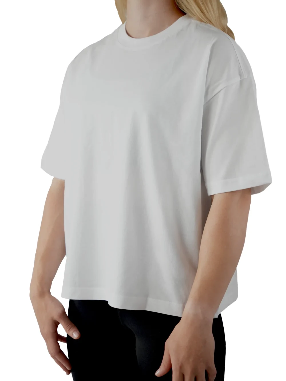 A female model wearing the white oversized boxy tee from the front, demonstrating its modern boxy silhouette and dropped shoulder fit.