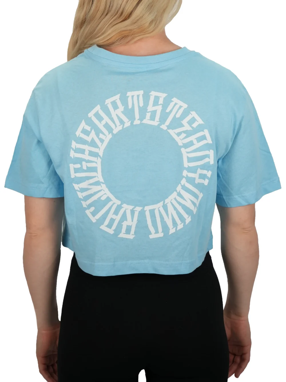 Model showing the back of the baby blue oversized tee and "Racing Heart Steady Mind" graphic, representing the RHSM calisthenics clothing brand.