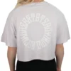 Model turning to show the back of the lilac oversized tee, highlighting the large "Racing Heart Steady Mind" graphic on the RHSM workout gear.