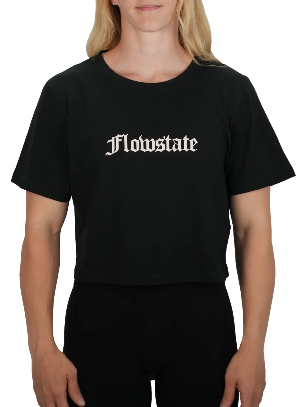 Model wearing the black RHSM Flowstate crop top, demonstrating the athletic cropped fit of the fitness apparel.
