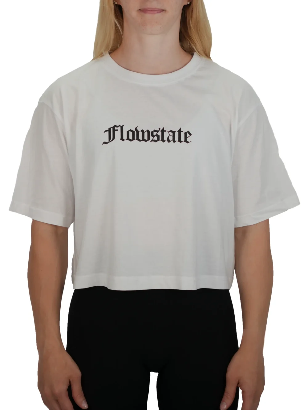 Model wearing the white RHSM Flowstate crop top, demonstrating the modern athletic cut of the women's fitness apparel.