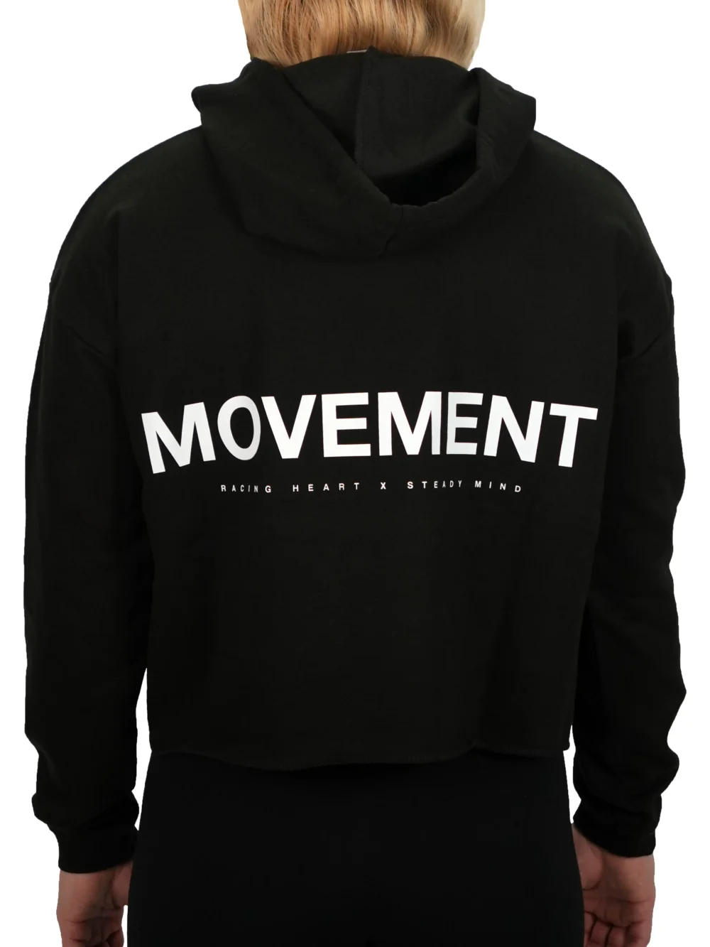 Model wearing the black RHSM MVMT cropped hoodie (back view), highlighting the signature white motivational "Movement" graphic and hood.