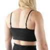 Model showing the back strap design of the black sports bra, representing the minimalist line from the RHSM calisthenics clothing brand.