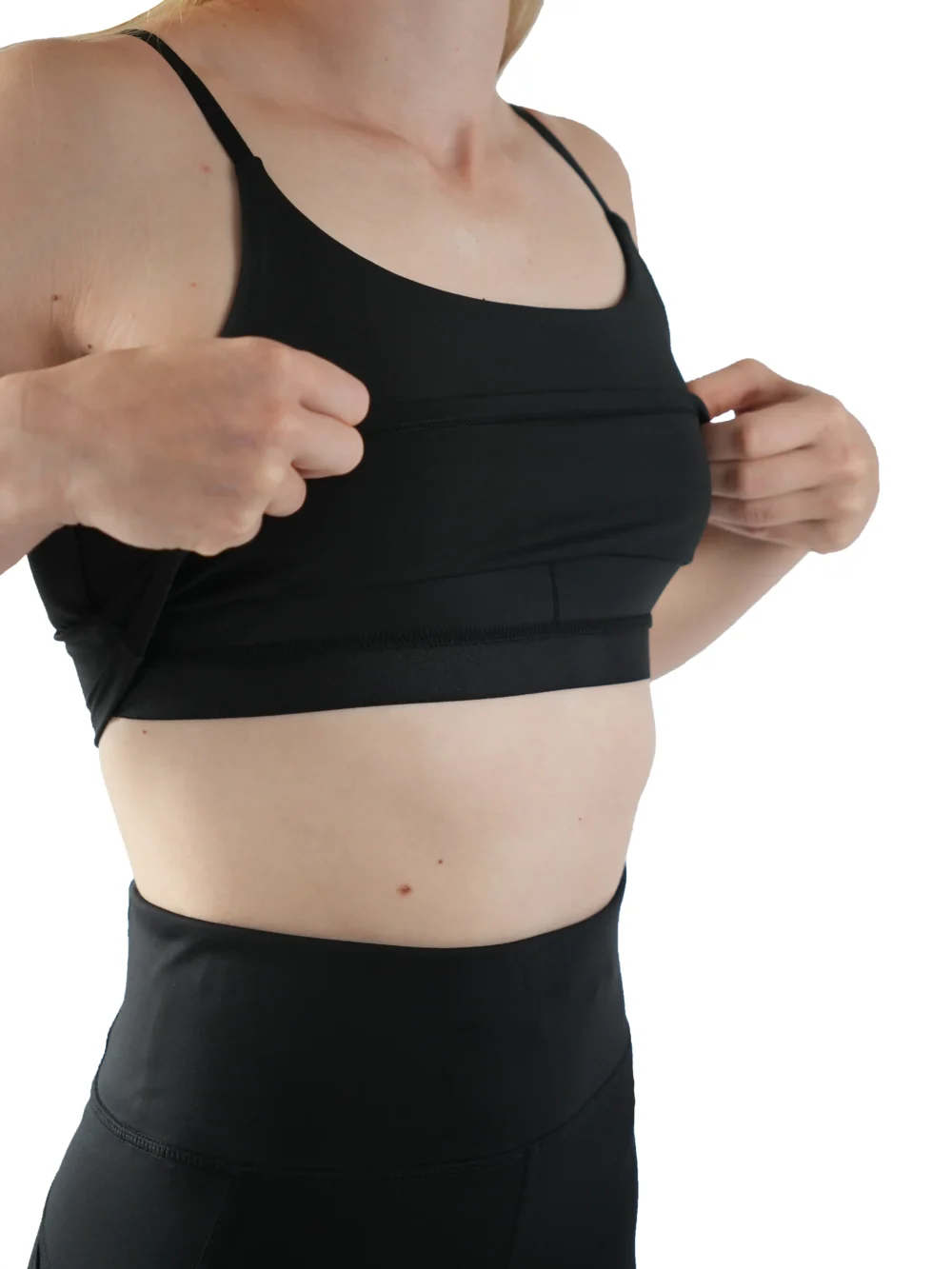 Close-up detail shot of the interior support structure and removable padding of the black RHSM Minimalist Sports Bra.