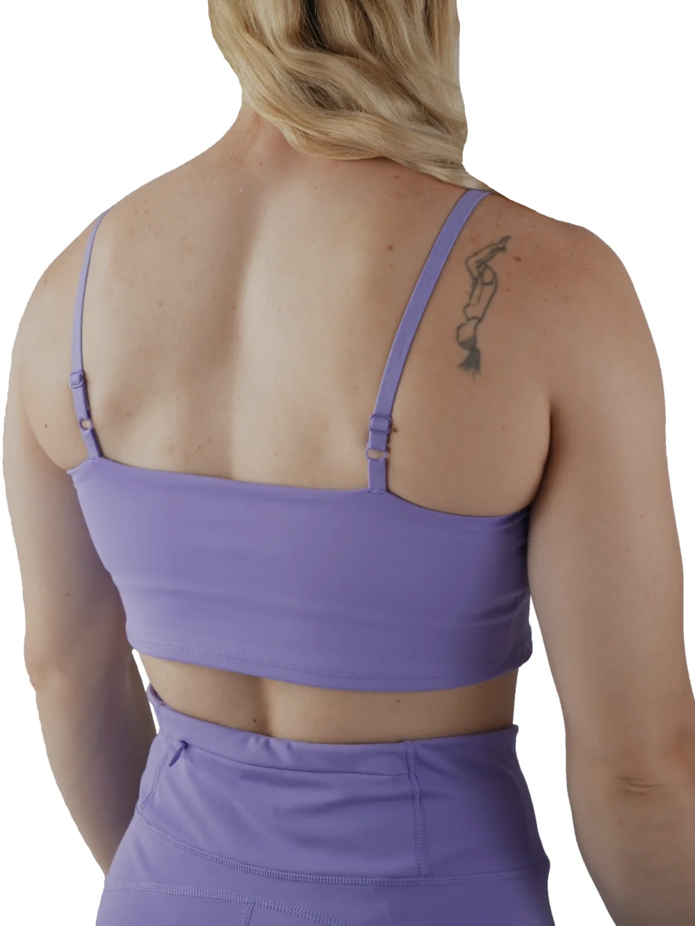 Model showing the back strap design of the lavender sports bra, from the RHSM calisthenics clothing brand.