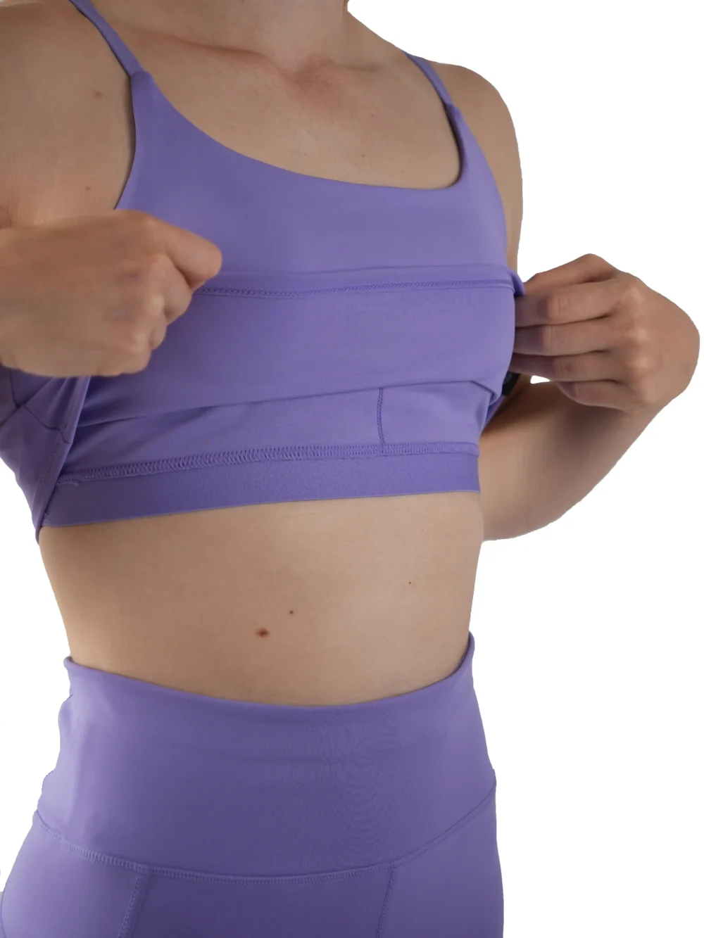 Detail shot showing the moisture-wicking interior and internal support structure of the lavender RHSM Minimalist Sports Bra.