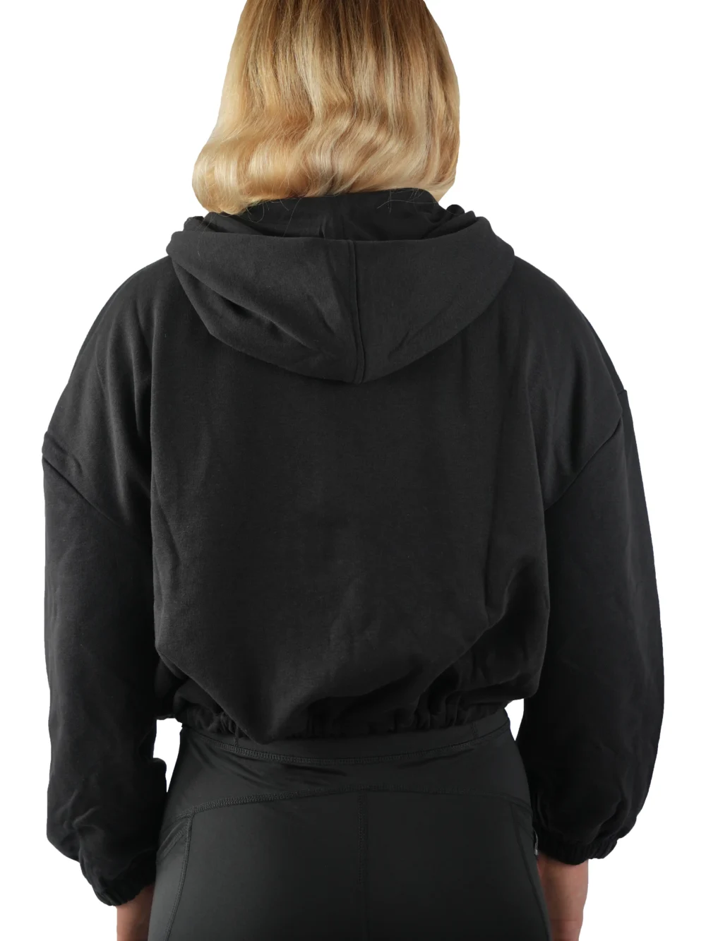 Model wearing the back of the black full-zip hoodie, showing the drape of the lightweight fleece.