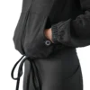 Model using both split front kangaroo pockets on the black RHSM minimalist hoodie, essential workout gear.