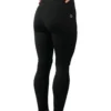 Model wearing the back of the black RHSM leggings, showing the ergonomic seams.