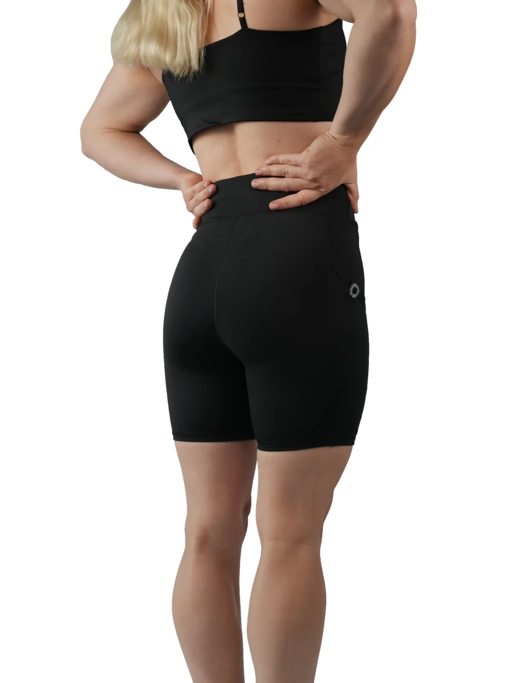 Model wearing the back of the black RHSM shorts, showing the contouring fit of the performance gear.
