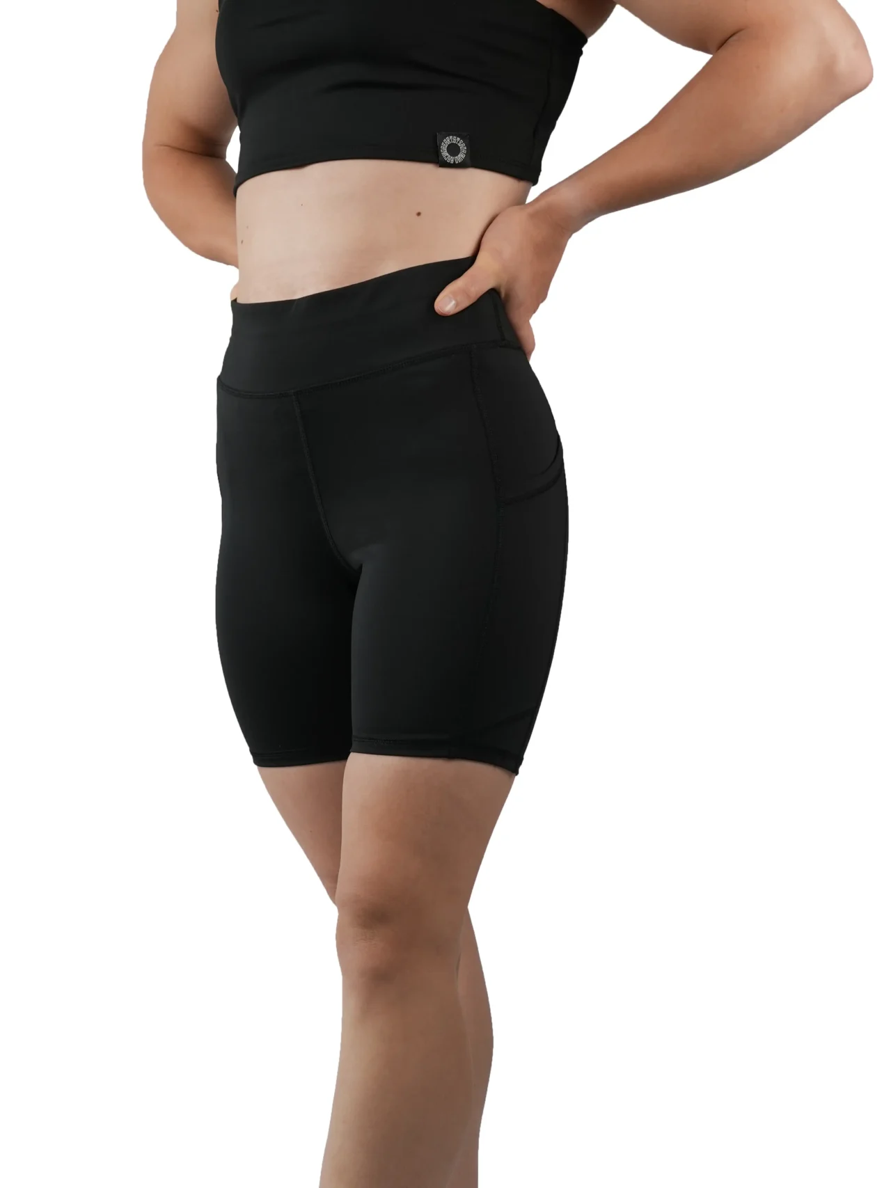 Model wearing the black RHSM Minimalist Shorts, showing the secure high-waist slim fit.