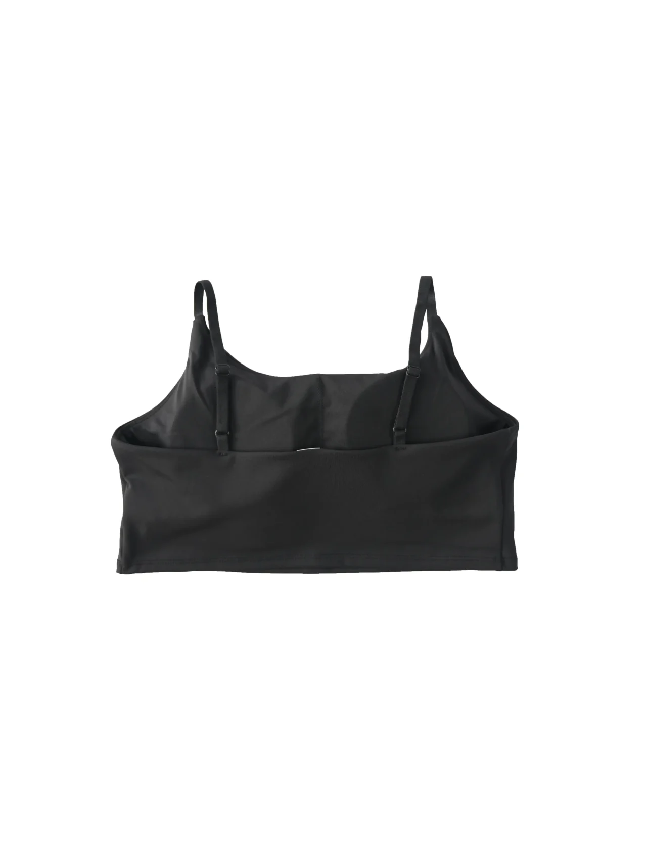 Back view of the black RHSM Minimalist Sports Bra laid flat, highlighting the secure spaghetti strap design of the workout gear.