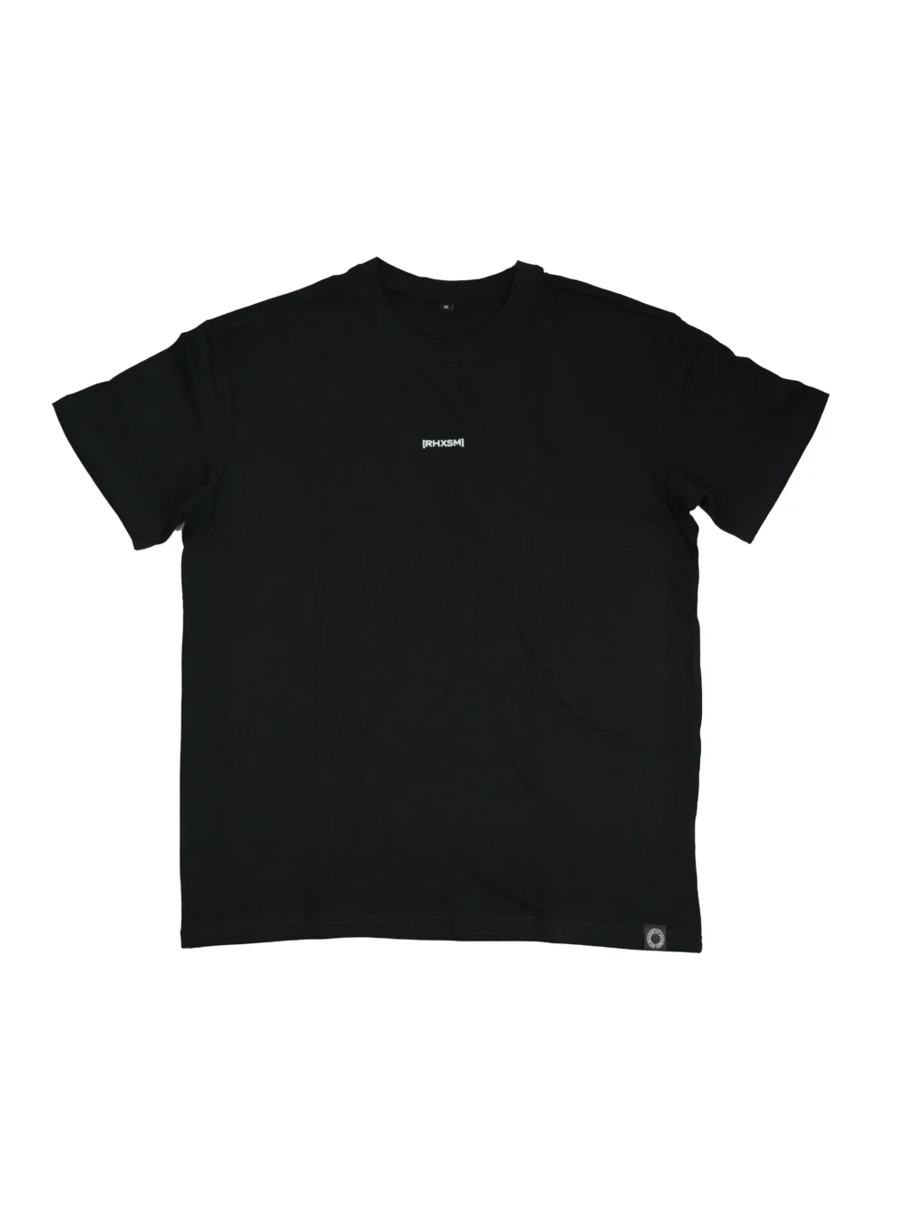 The RHSM "[RHXSM]" Oversized Tee in black, laid flat (front view), showing the minimalist chest graphic and sewn-in hem label on this 100% cotton fitness apparel.