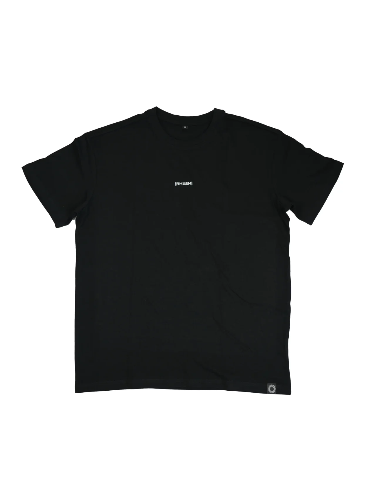 The RHSM "[RHXSM]" Oversized Tee in black, laid flat (front view), showing the minimalist chest graphic and sewn-in hem label on this 100% cotton fitness apparel.