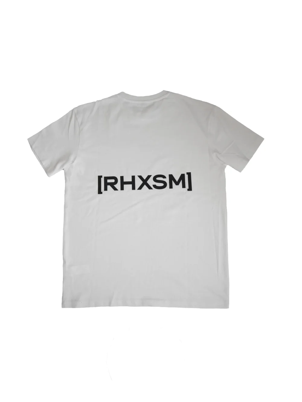The white "[RHXSM]" oversized tee, laid flat (back view), detailing the bold statement back graphic on this piece of calisthenics apparel.