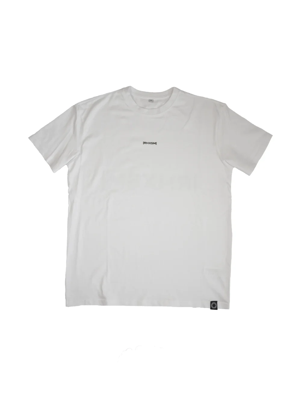 The RHSM "[RHXSM]" Oversized Tee in white, laid flat (front view), highlighting the clean front print and premium sewn-in label on this 100% cotton fitness apparel.