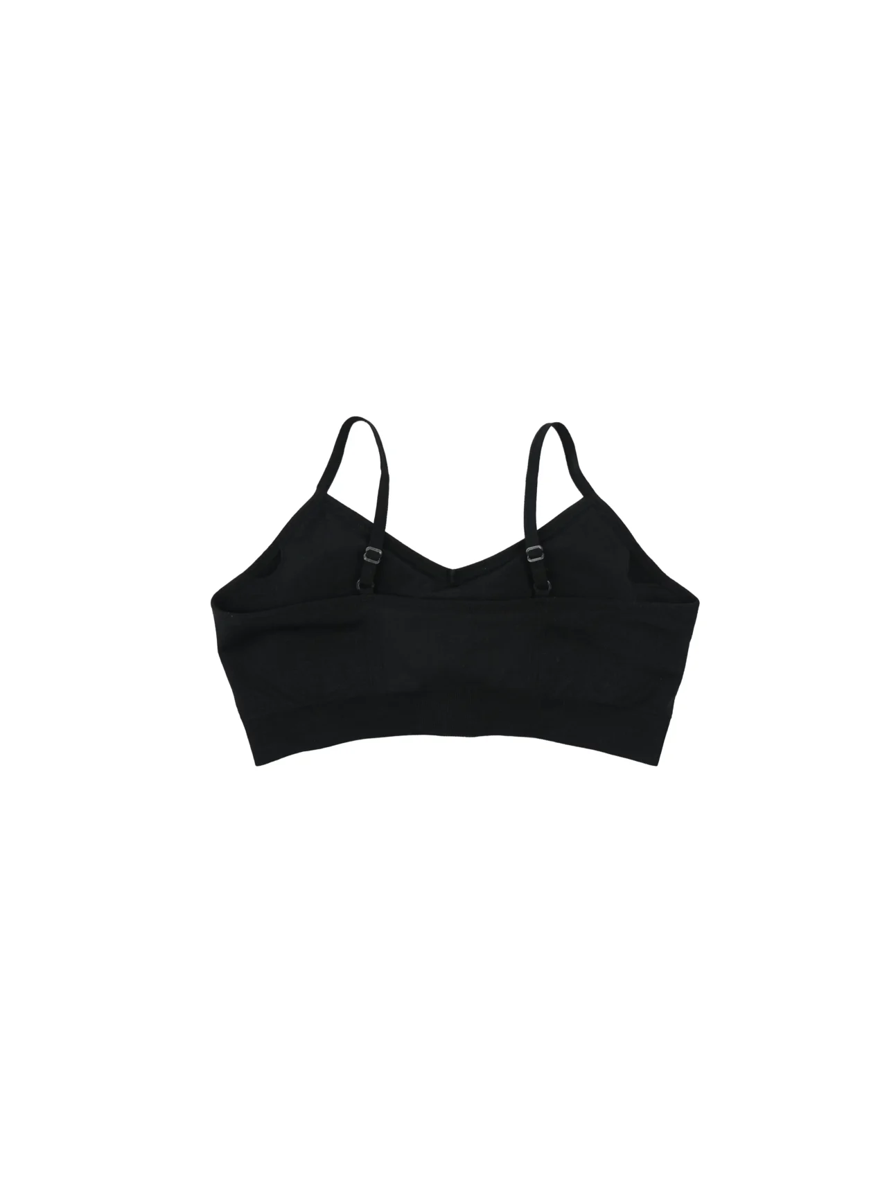 The black "[RHXSM]" sports bra, laid flat (back view), highlighting the seamless construction and ribbed detailing on the back; essential calisthenics apparel for women.