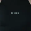 A close-up of the black "[RHXSM]" crop top, detailing the subtle front graphic and sewn-in hem label on this piece of performance apparel.