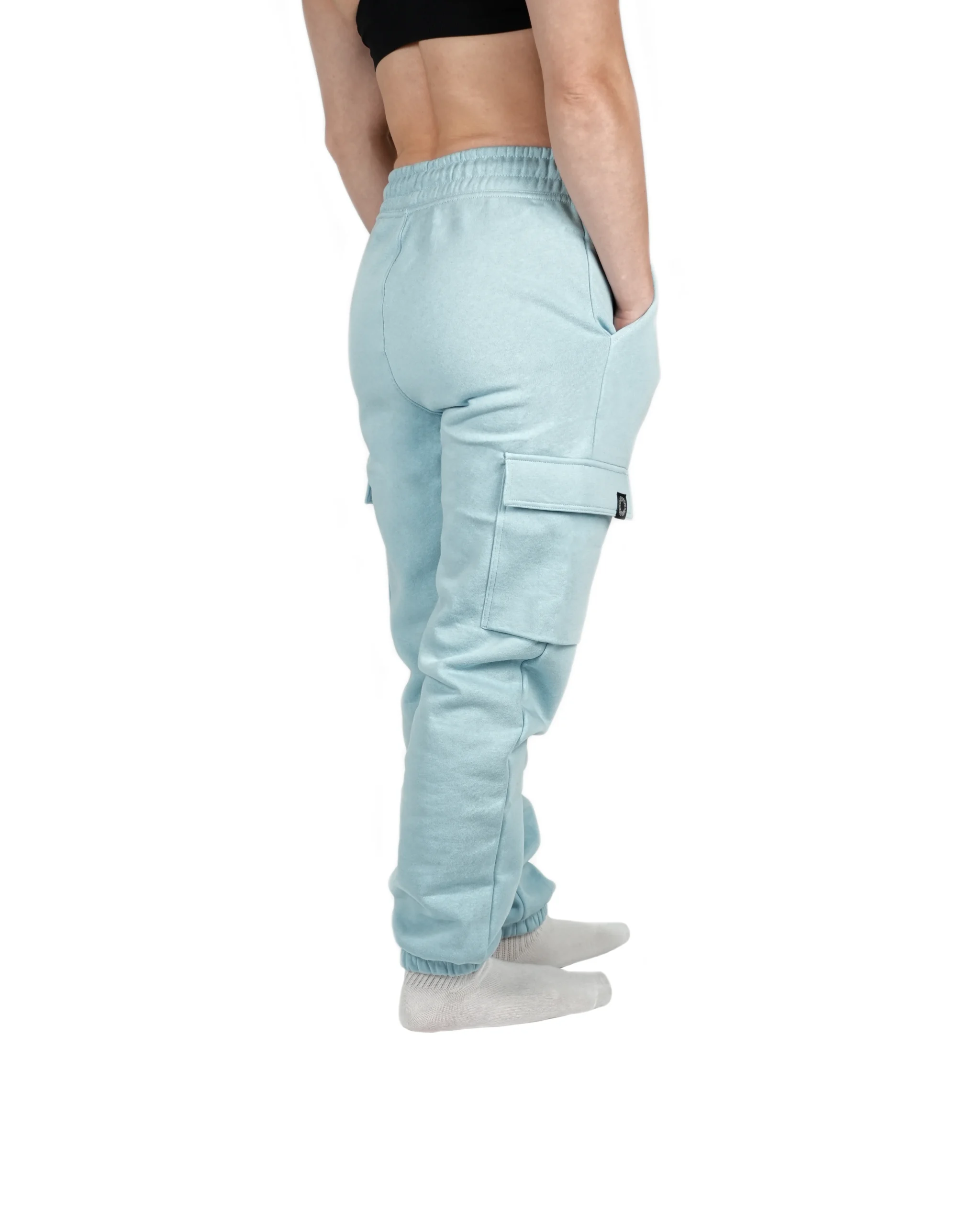 Rear view of model in Baby Blue RHSM cargo sweatpants, displaying the ribbed ankle cuffs that keep the pants secure during training.