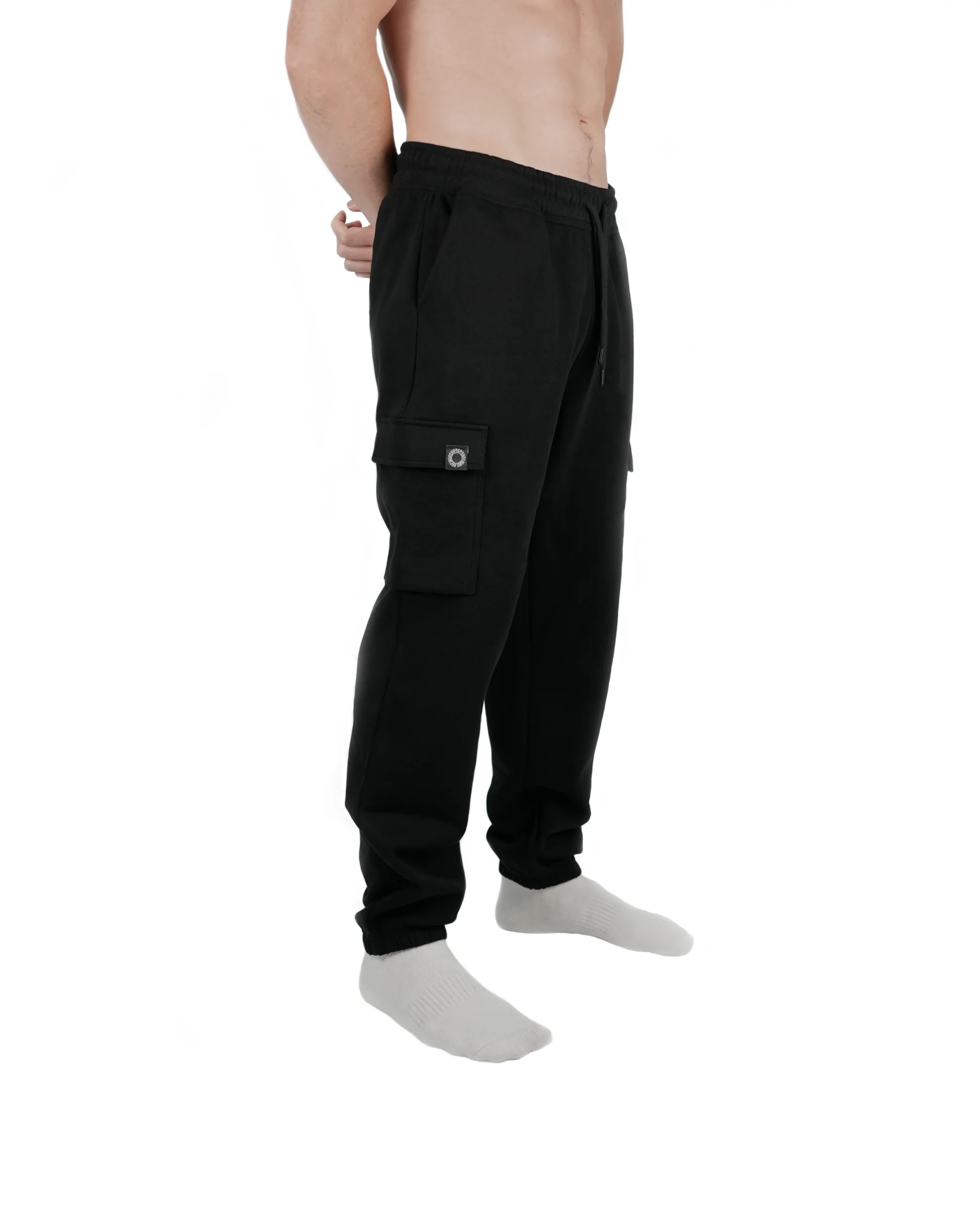 Athlete standing wearing black RHSM lightweight cargo sweatpants, highlighting the drawstring fit and cargo pockets, ideal workout gear for calisthenics.
