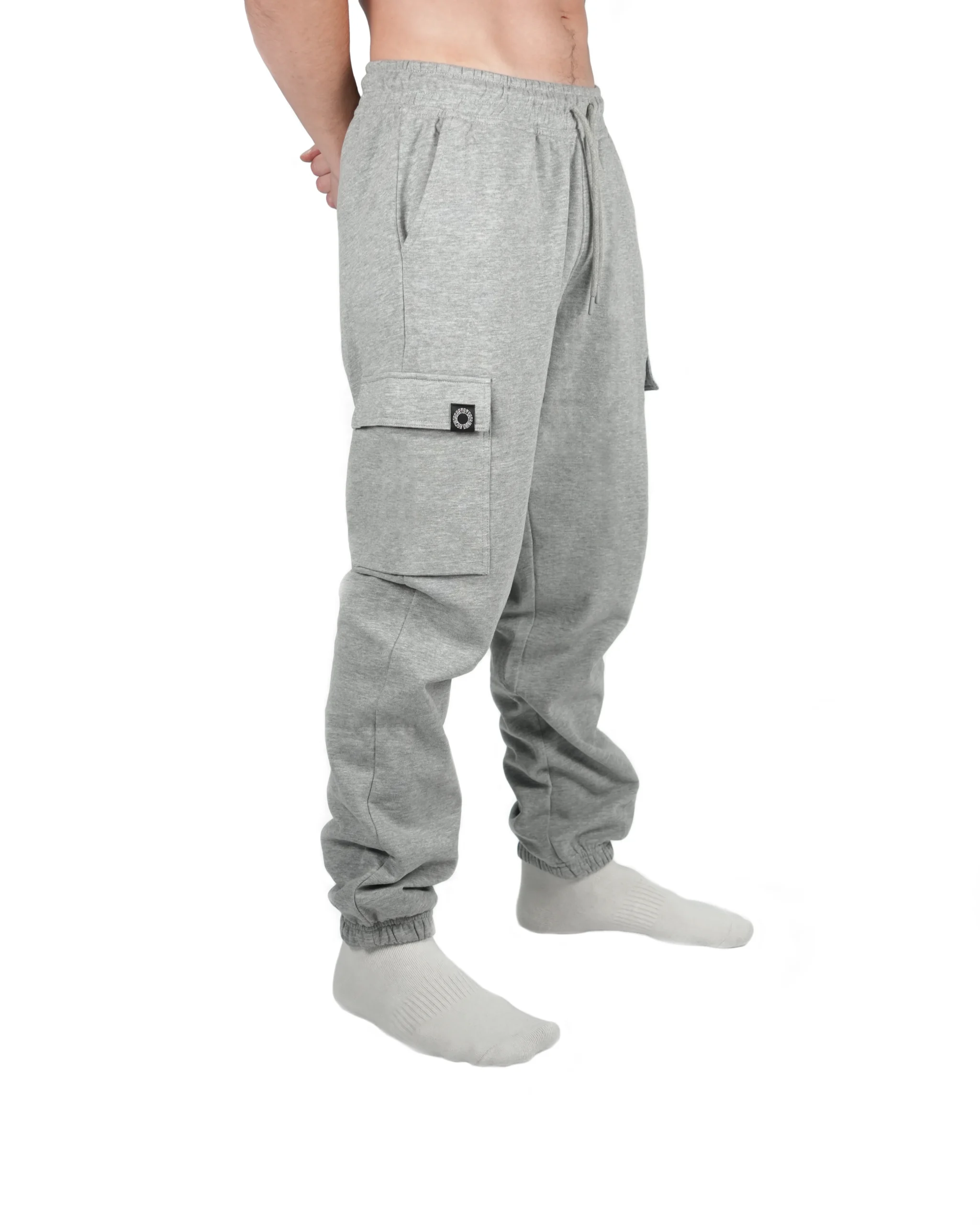 Front view of a model wearing gray RHSM cargo sweatpants, demonstrating the relaxed yet athletic fit perfect for high-intensity calisthenics apparel.