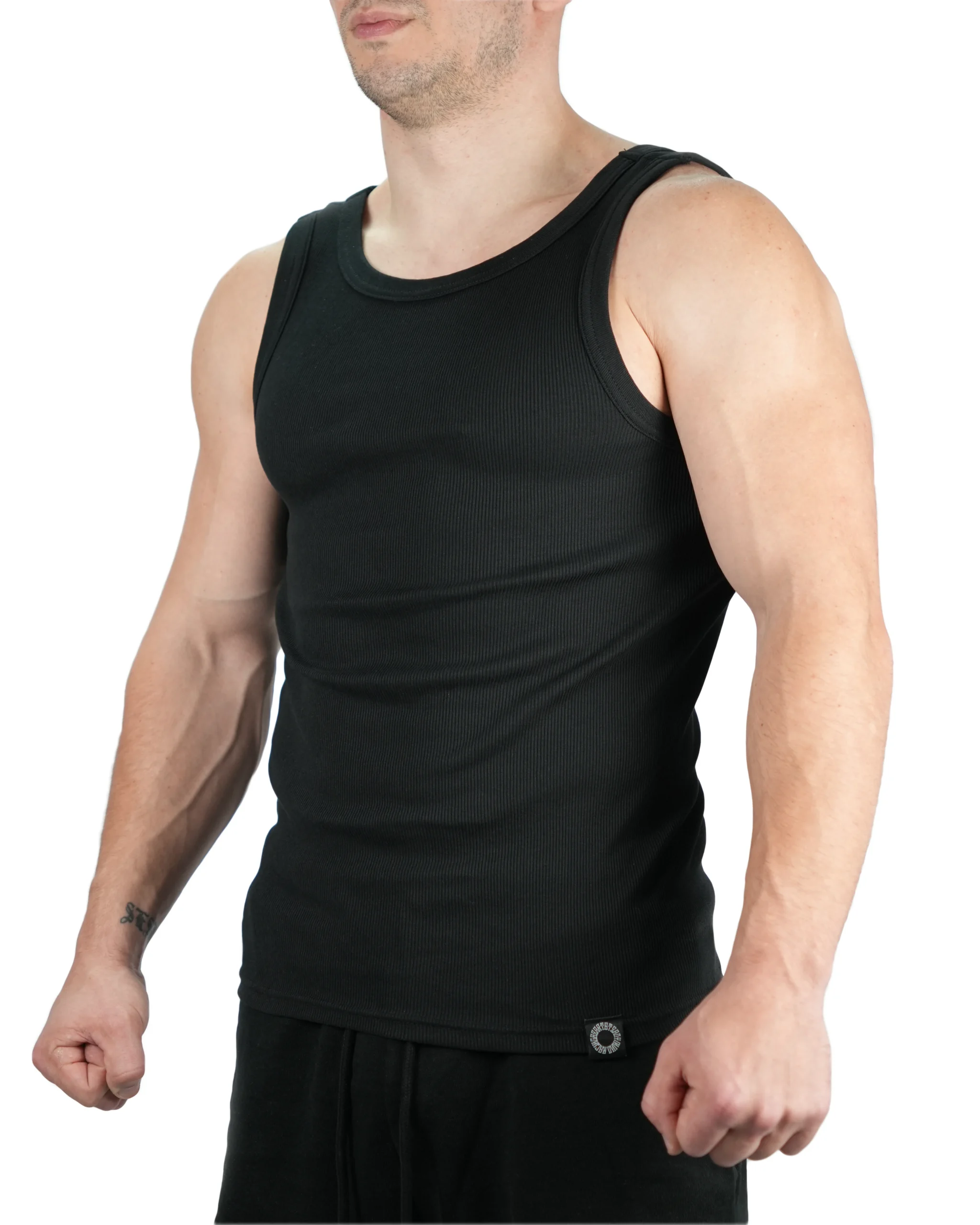 Athlete wearing black RHSM Minimalist Ribbed Tank, showing defined fit and premium fabric for high-performance fitness apparel.